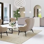 Empfangsbereich mit Lounge-Sesseln, Tisch und moderner Febrü-Einrichtung in hellem, stilvollem Büro.